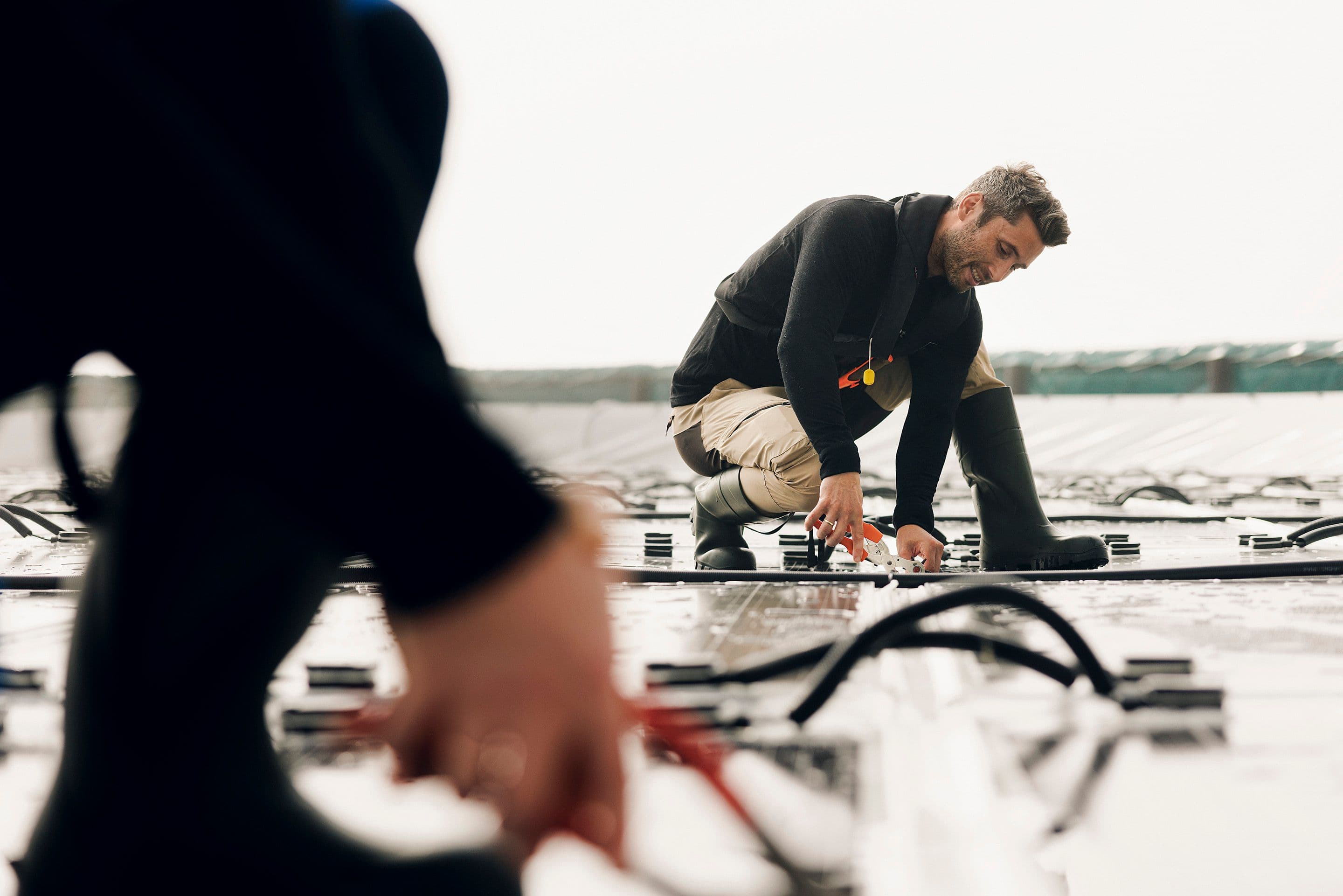 A person working on a floating solar power plant